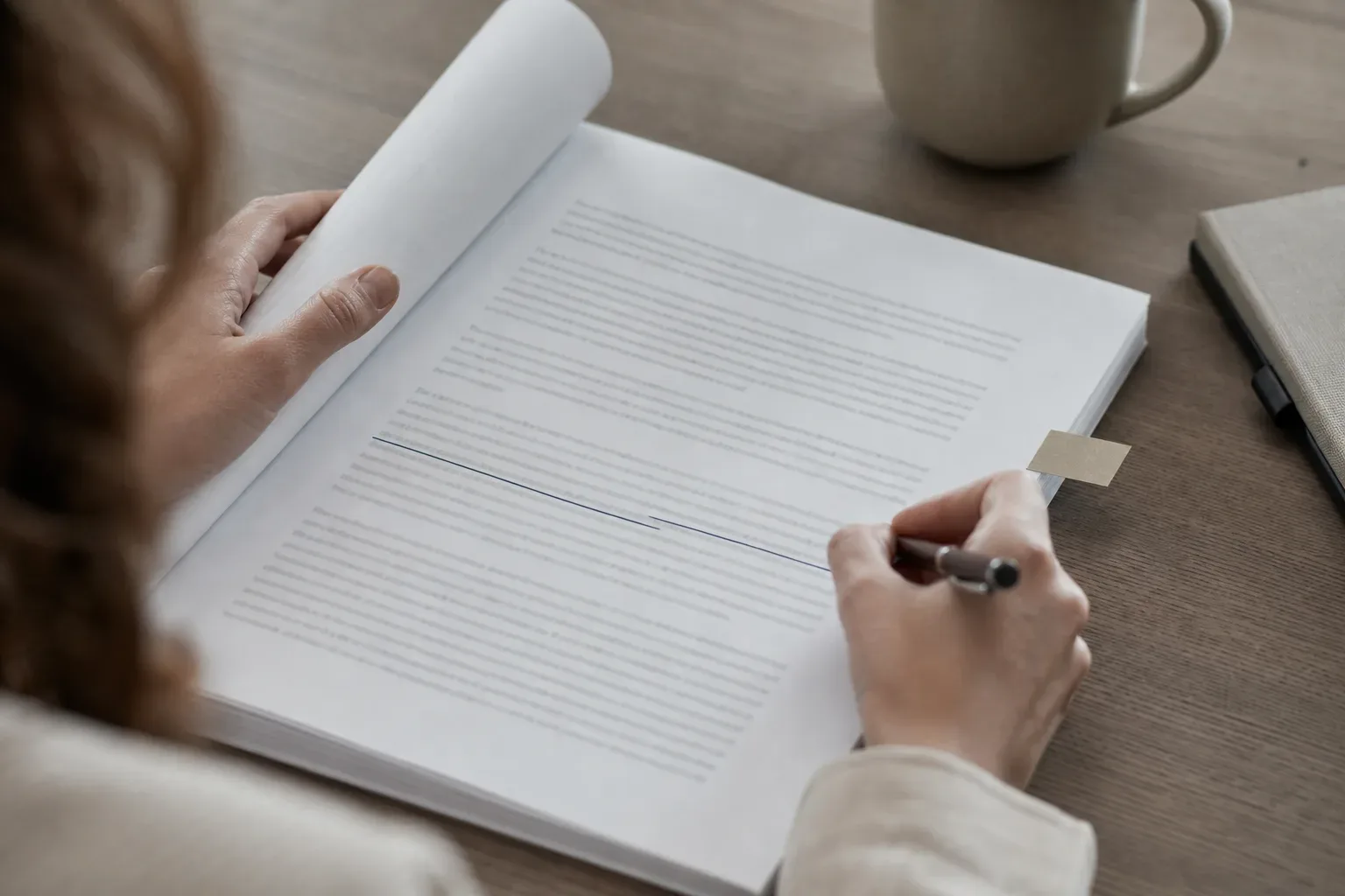 A legal text page with an interest rate cap clause clearly marked with a tab and underlined in ink